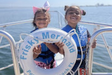 a person standing next to a body of water