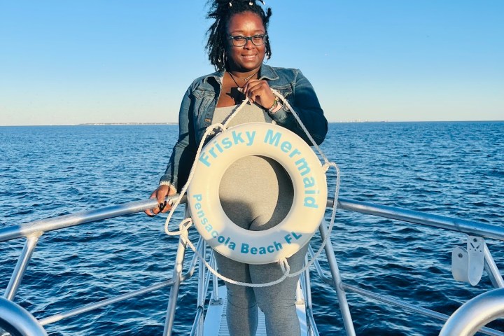 a person standing next to a body of water