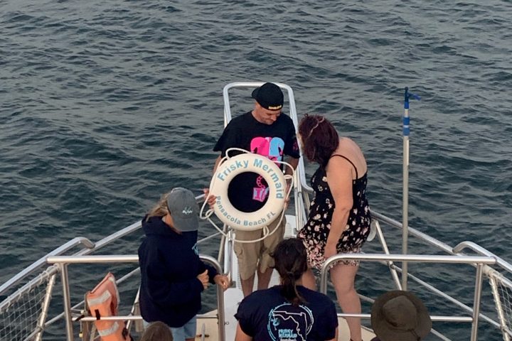 a group of people standing next to a body of water