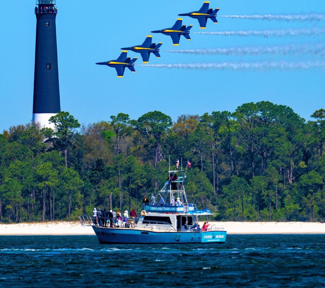 4 Blue Angels fly over Frisky Mermaid which is in front of the Pensacola Lighthouse for Blues Practice.