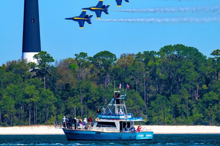 4 Blue Angels fly over Frisky Mermaid which is in front of the Pensacola Lighthouse for Blues Practice.