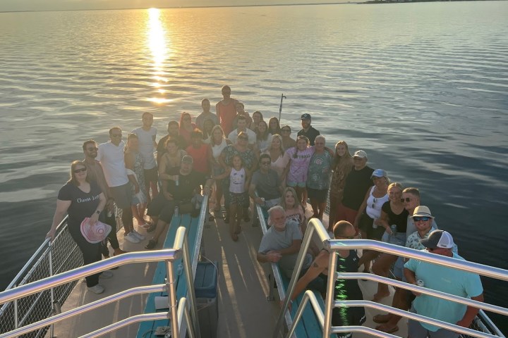 family reunion on a boat with a sunset