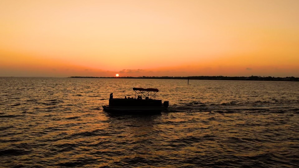 Pontoon boat rental taking in a Pensacola sunset
