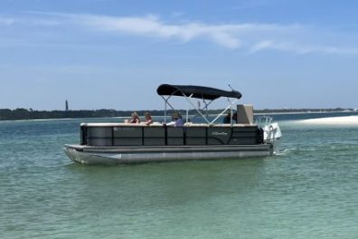 Pontoon boat with shade beached at secluded beach