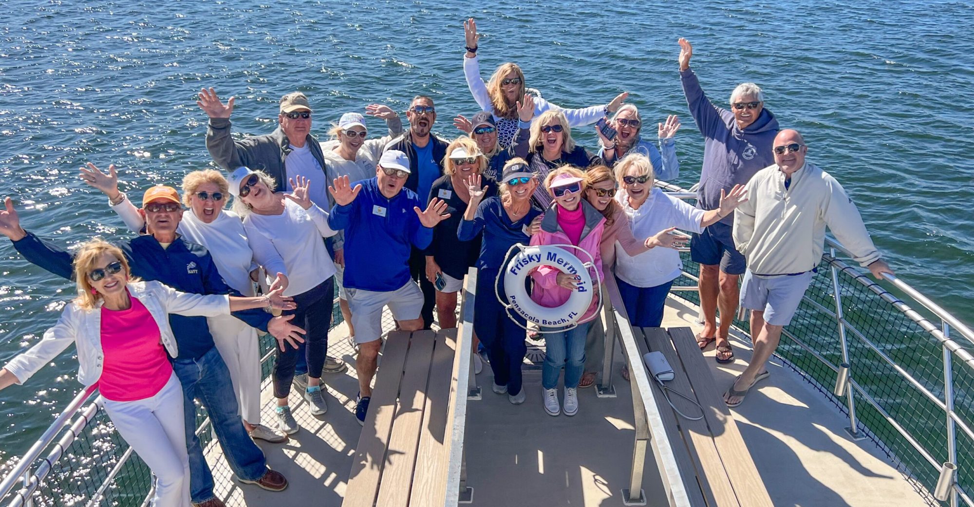 a group of guests enjoying fun in the sun onboard Frisky Mermaid in Sabine Bay