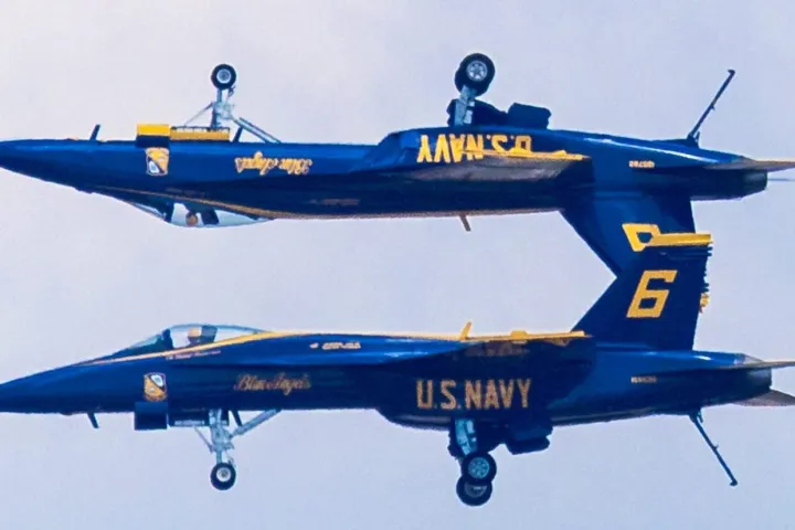 two blue angel fighter jets upside down maneuver over Pensacola