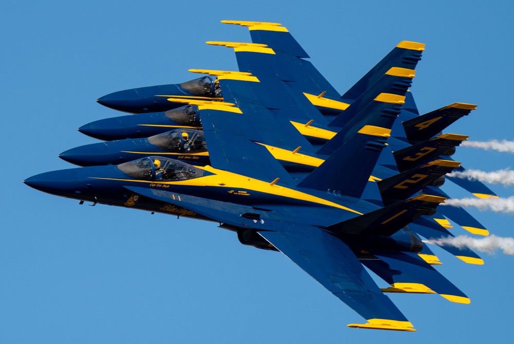 U.S. Navy Blue Angels flying in tight formation over Pensacola during a Blue Angels Practice + Dolphin Tour experience on Santa Rosa Sound