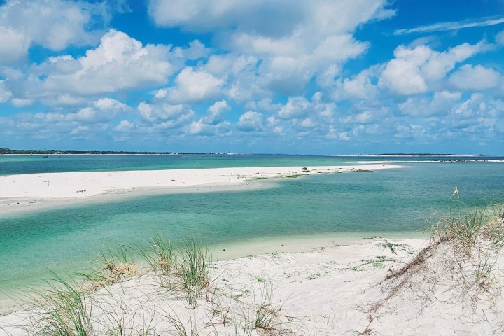 Pristine white sand and emerald waters along Santa Rosa Sound near Pensacola Beach on a calm coastal day