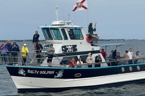 Salty Dolphin tour boat cruising in Santa Rosa Sound near Pensacola Beach, Florida with guests onboard