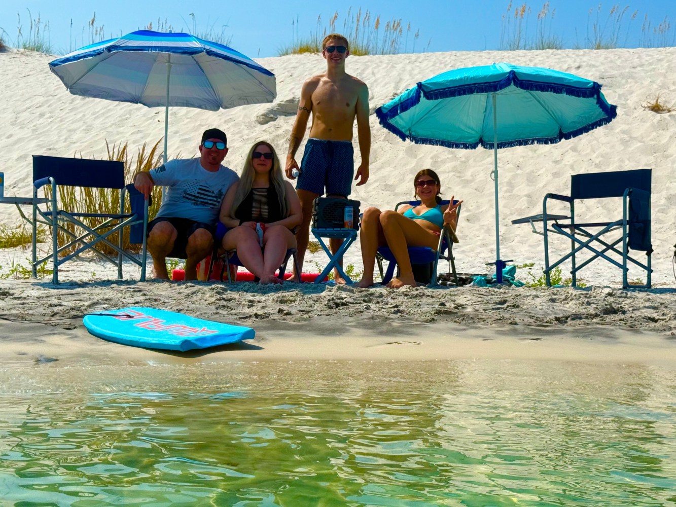 Group relaxing on a quiet sandbar beach near Pensacola Beach during a private boat tour.