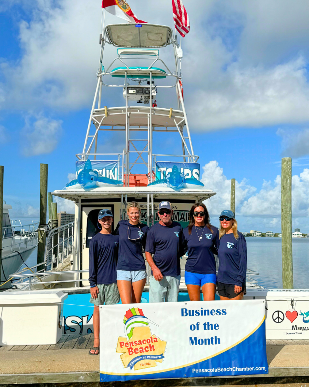 Mermaid Crew posing for April Business of the Month Banner